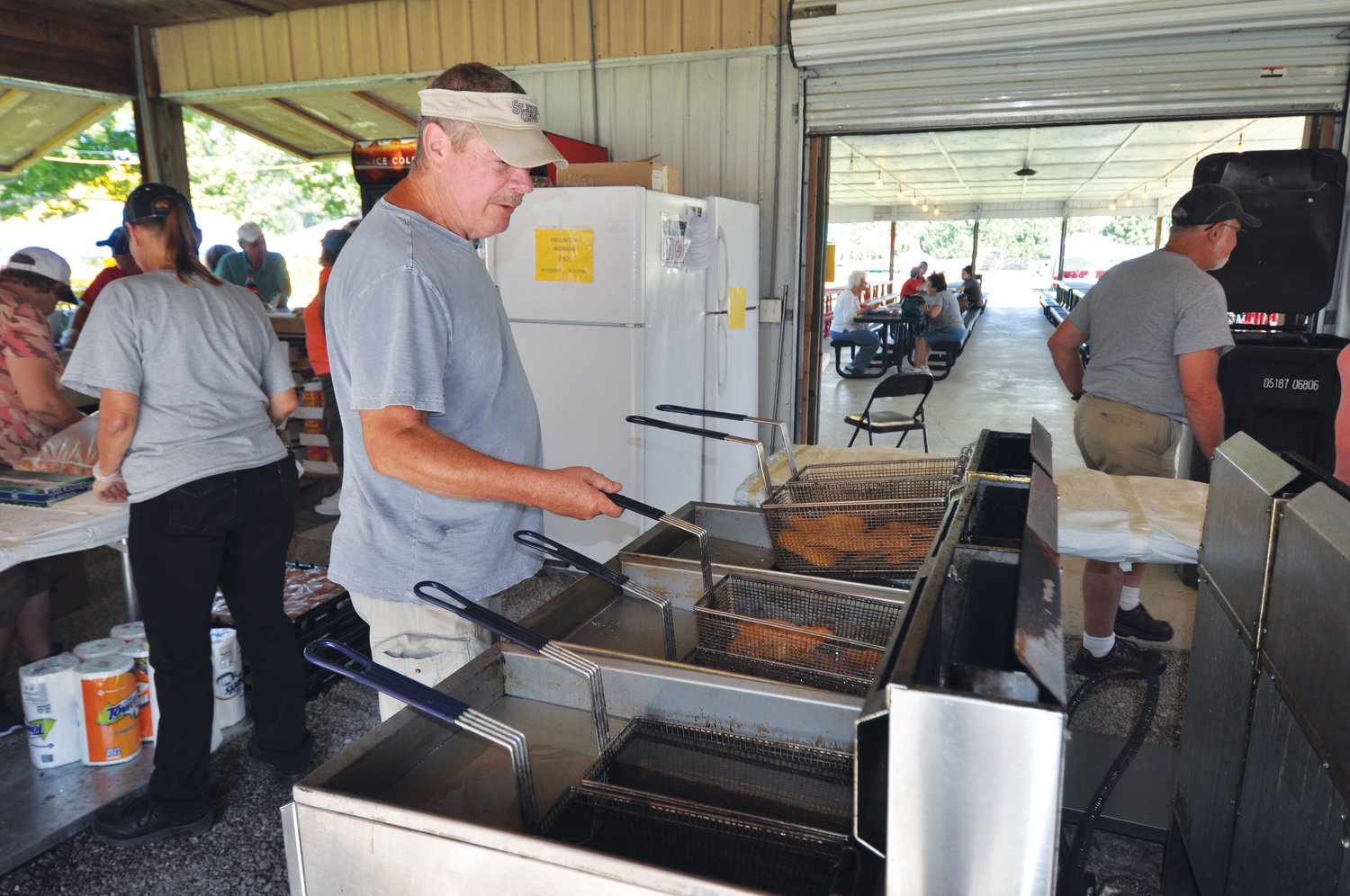 Steve Proctor takes fish out of the fryer at the Waynetown Fish Fry.
